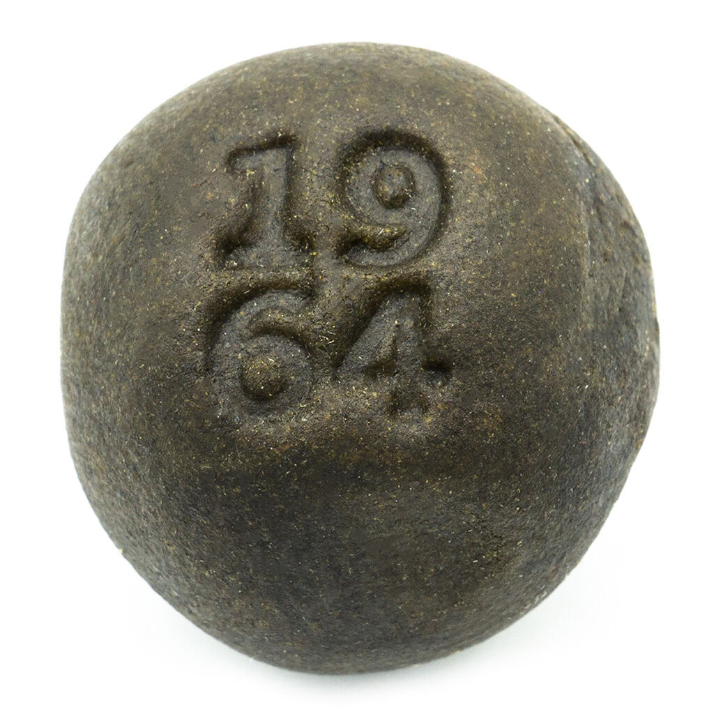 1964 Lebanese Hash pressed into a smooth, round coin shape with stamped branding on the surface.