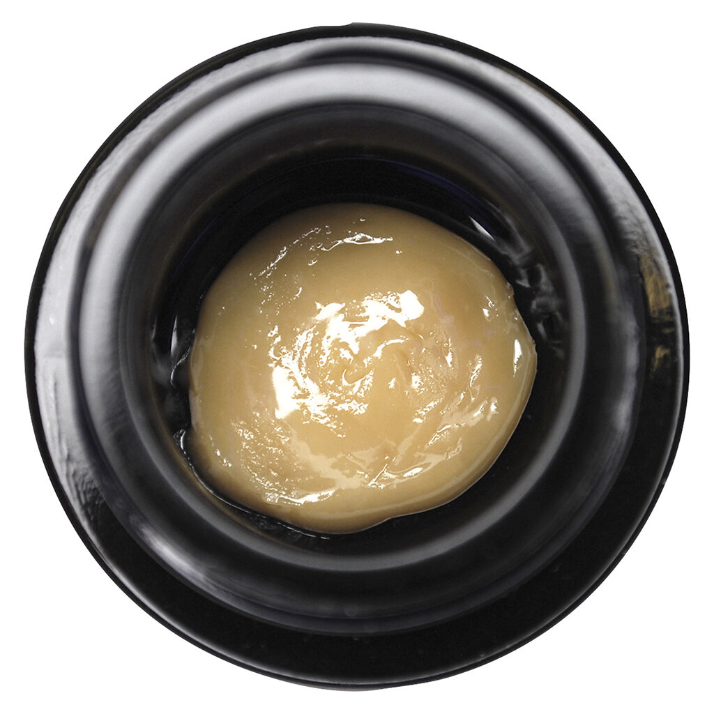 Close-up of premium live rosin cannabis concentrate with smooth, creamy texture in a black jar.