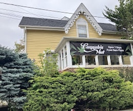 Cannabis Hut dispensary storefront in Mississauga with yellow exterior and branded signage