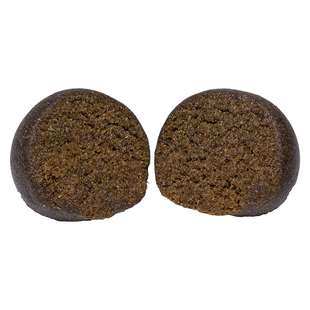 Carmel Animal Face Temple Ball Hash cut open to reveal a soft, rich, resin-packed interior with a smooth outer shell.